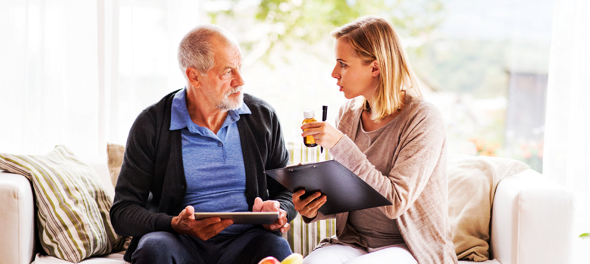 an elderly man with a caregiver woman